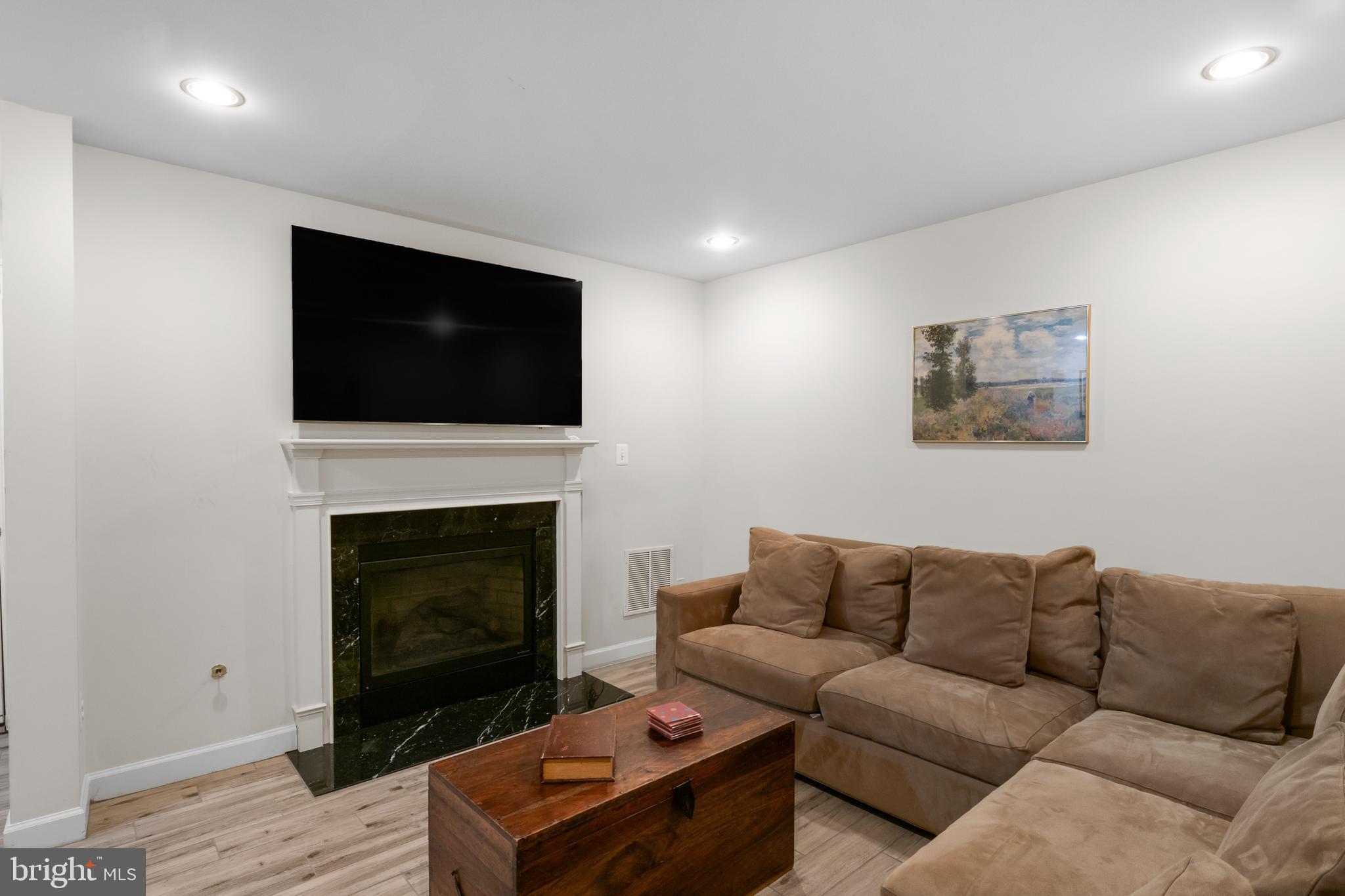 419 Princess Street Alexandria, VA 22314 - Photo 35 of 44 a living room with furniture a fireplace and a flat screen tv
