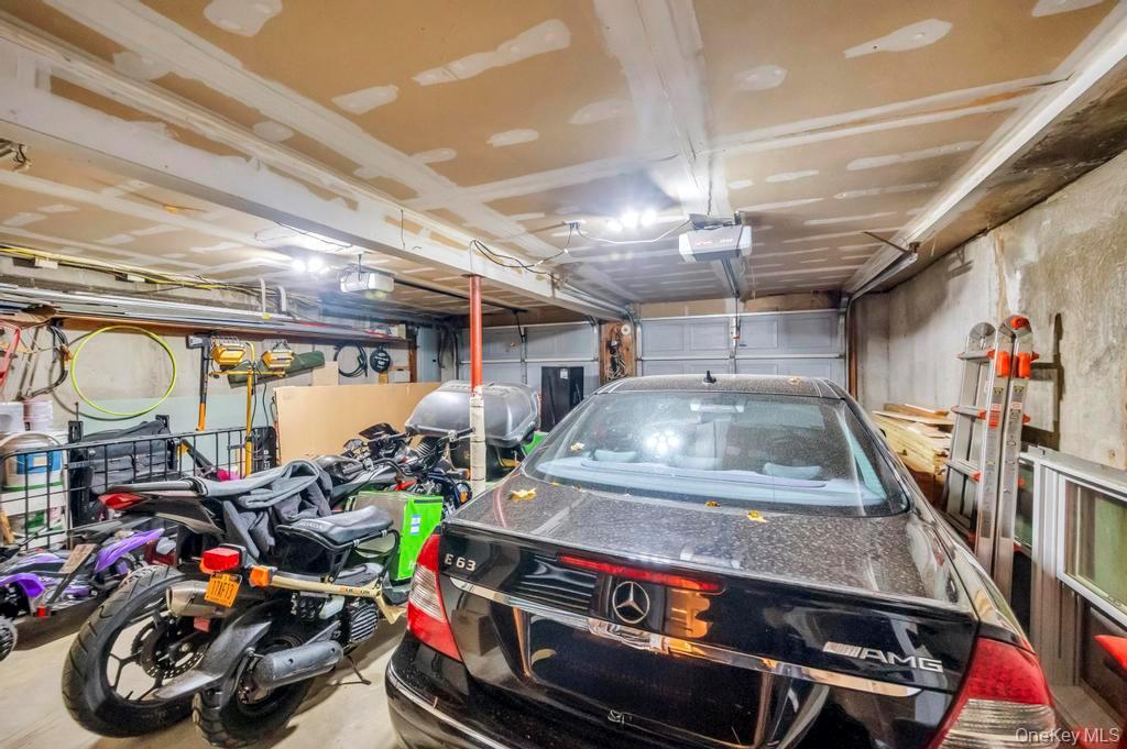 39 Bevin Road Northport, NY 11768 - Photo 38 of 44 Garage featuring oil tank, a garage door opener, and electric panel