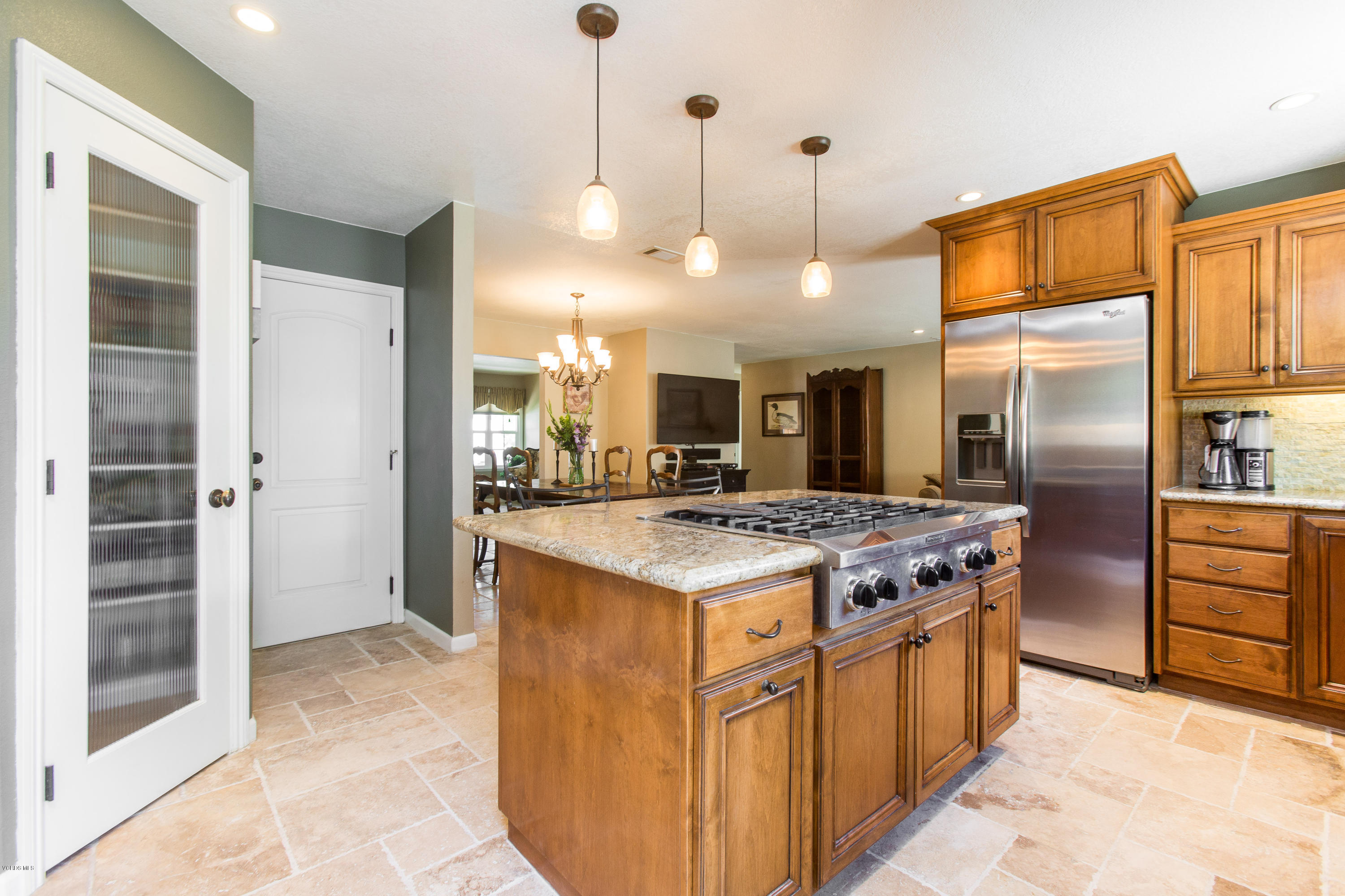 1177 Rambling Road Simi Valley, CA 93065 - Photo 12 of 56 a kitchen with kitchen island a stove a refrigerator and a view of living room