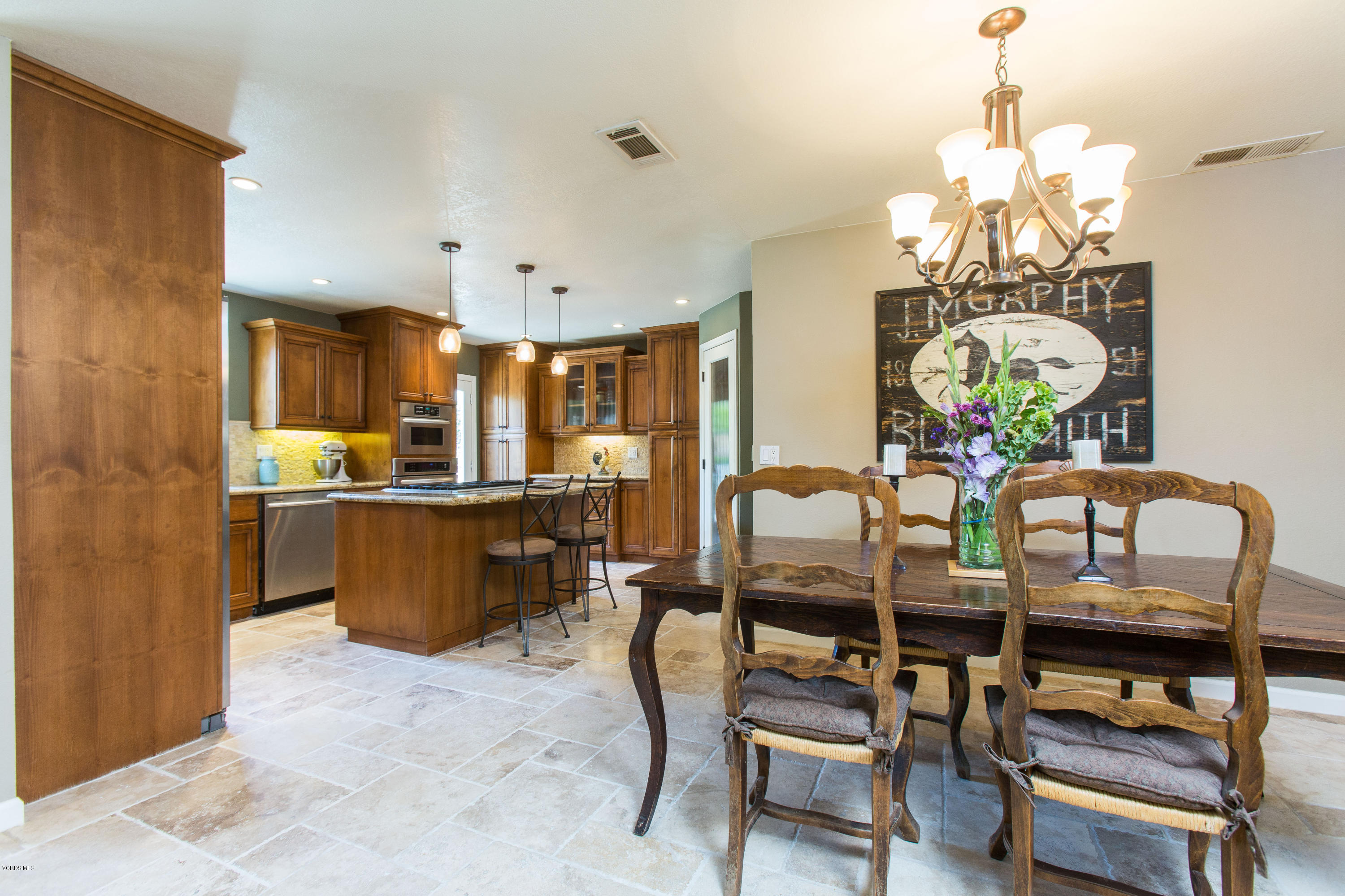 1177 Rambling Road Simi Valley, CA 93065 - Photo 14 of 56 a dining room filled chandelier and kitchen view