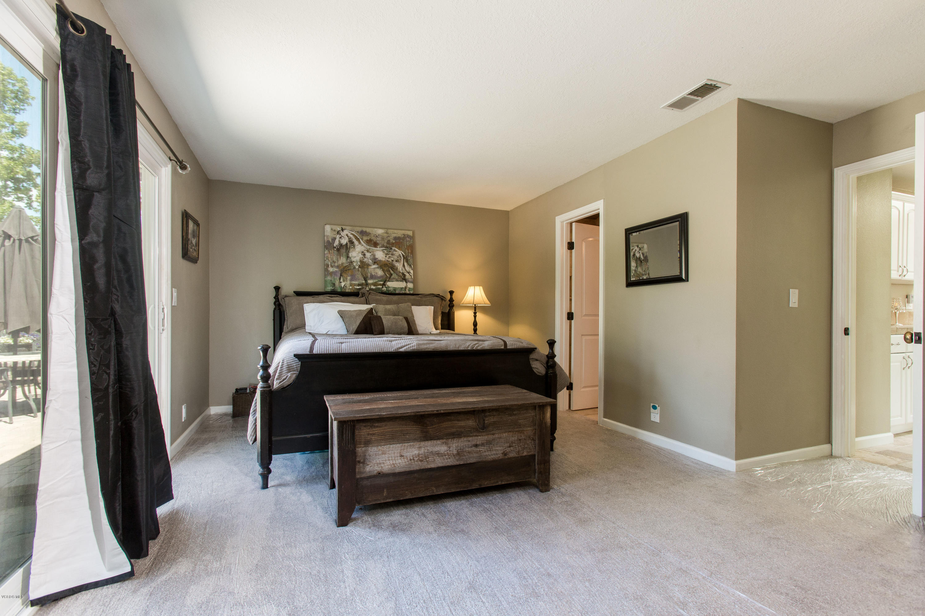 1177 Rambling Road Simi Valley, CA 93065 - Photo 21 of 56 a bedroom with a bed and a flat tv screen next to a window