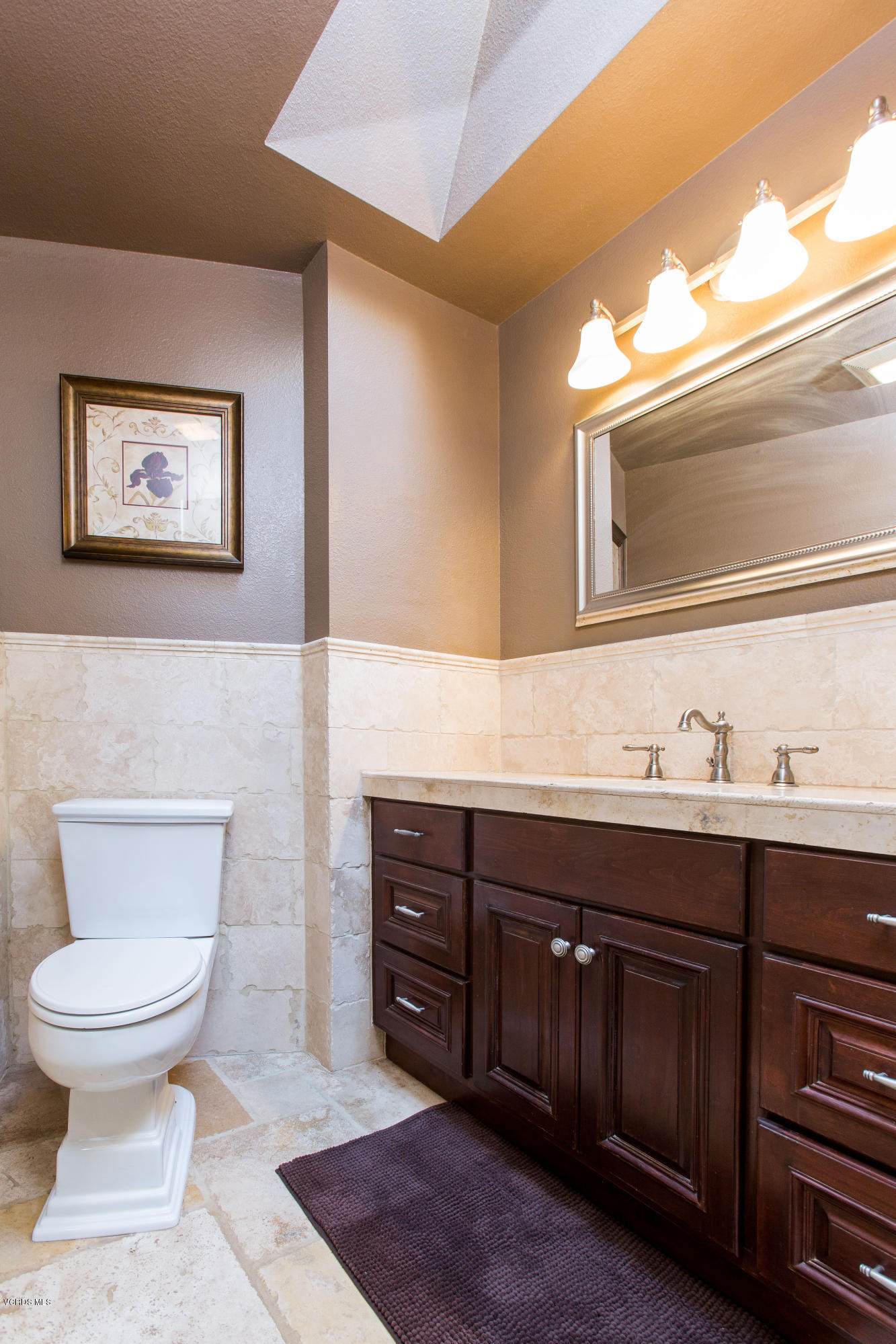 1177 Rambling Road Simi Valley, CA 93065 - Photo 23 of 56 a bathroom with a toilet a sink and mirror