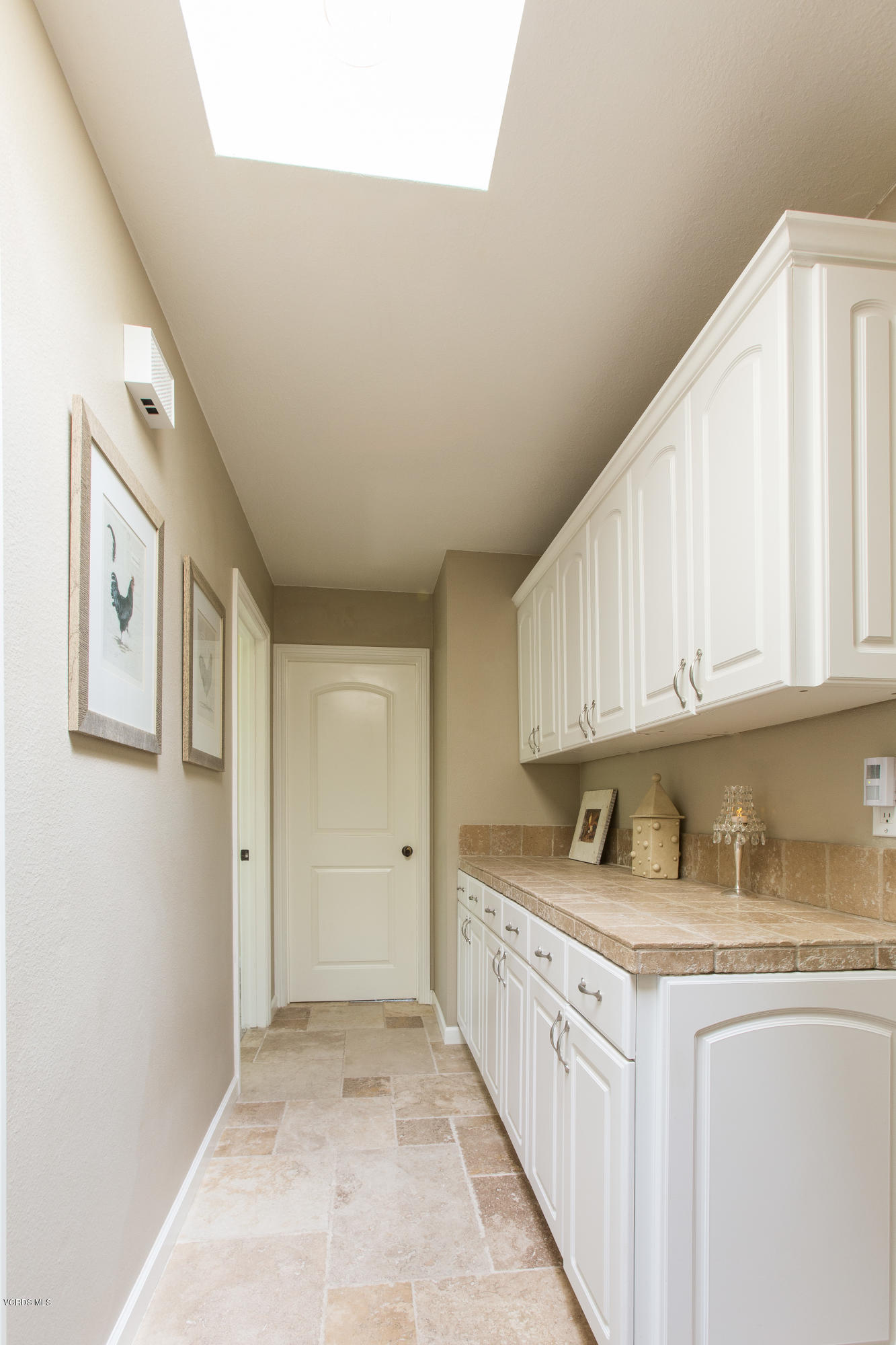 1177 Rambling Road Simi Valley, CA 93065 - Photo 27 of 56 a kitchen with granite countertop a sink and cabinets