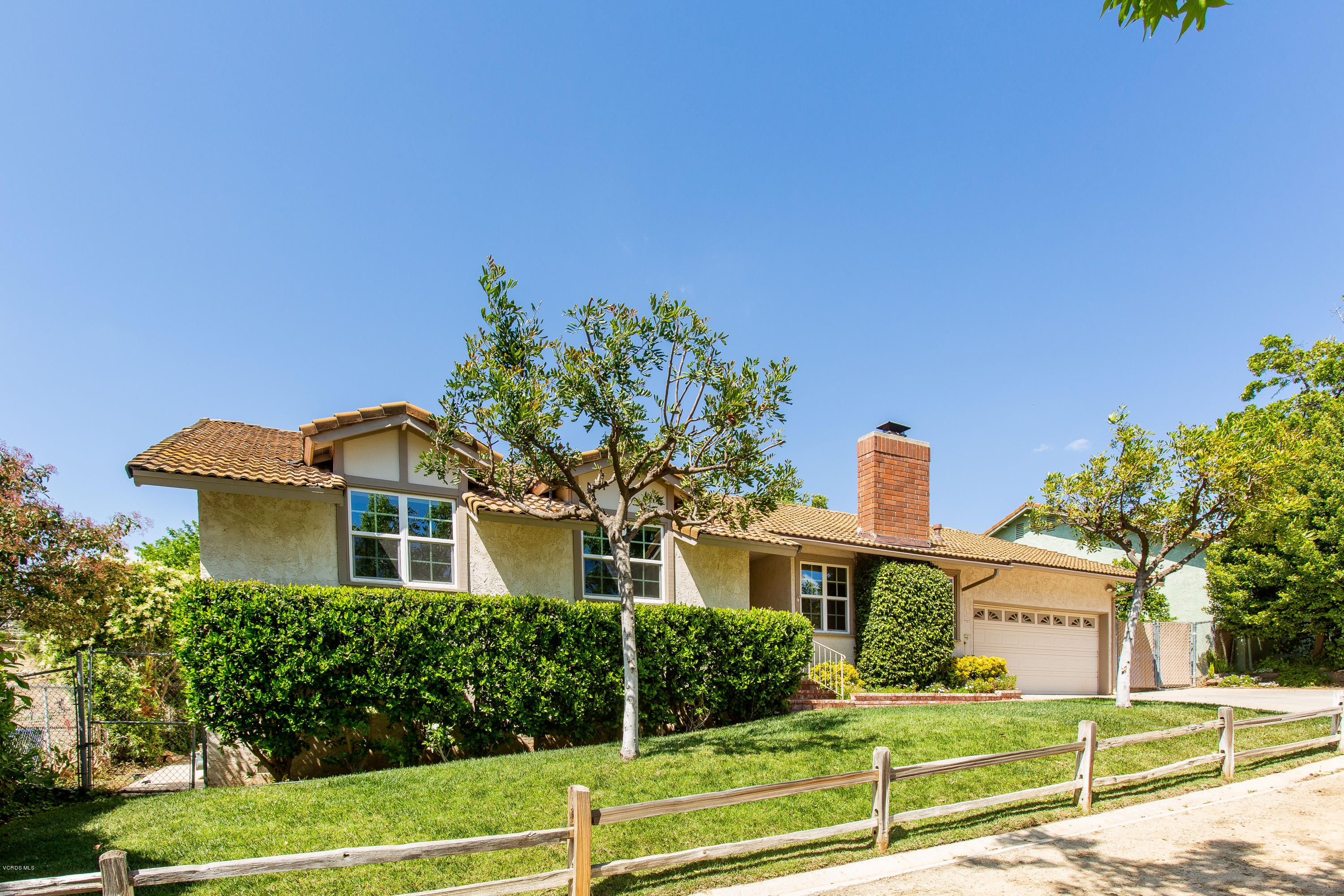 1177 Rambling Road Simi Valley, CA 93065 - Photo 5 of 56 a front view of a house with a yard