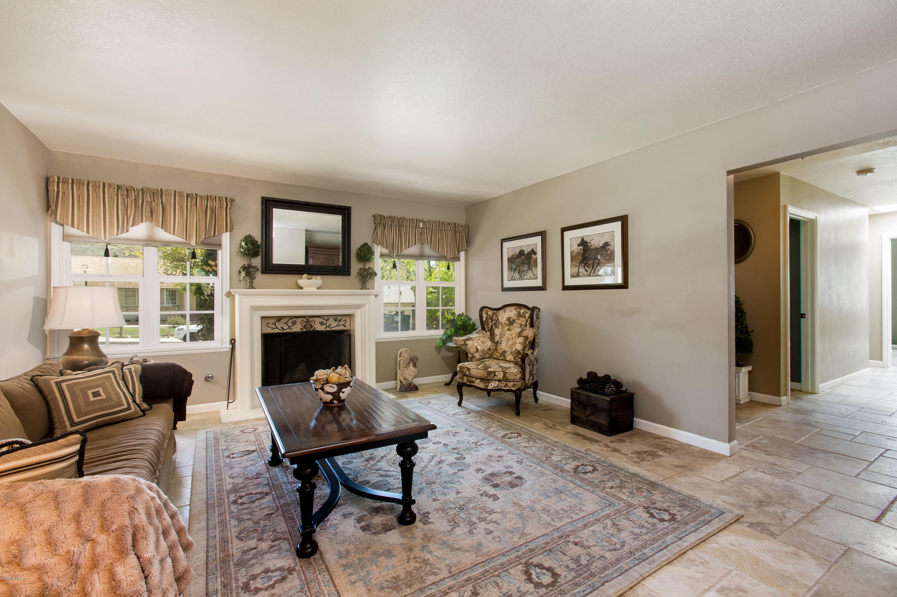1177 Rambling Road Simi Valley, CA 93065 - Photo 8 of 56 a living room with furniture a rug and a fireplace