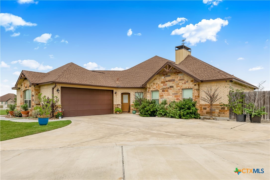 254 Sendera Loop Victoria, TX 77904 - Photo 6 of 48 a front view of a house with a yard and garage