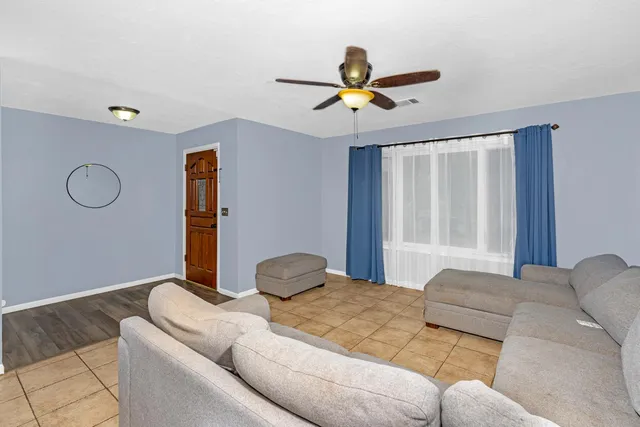 a living room with furniture and a chandelier