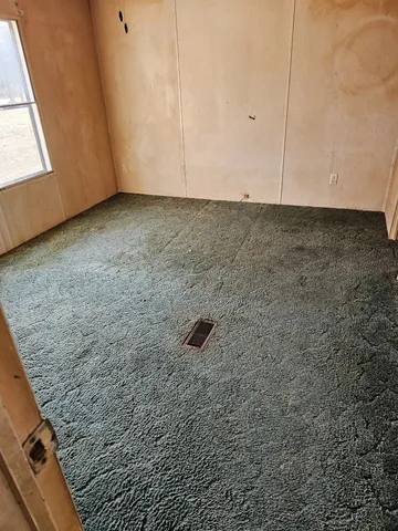 a view of backyard with wooden fence