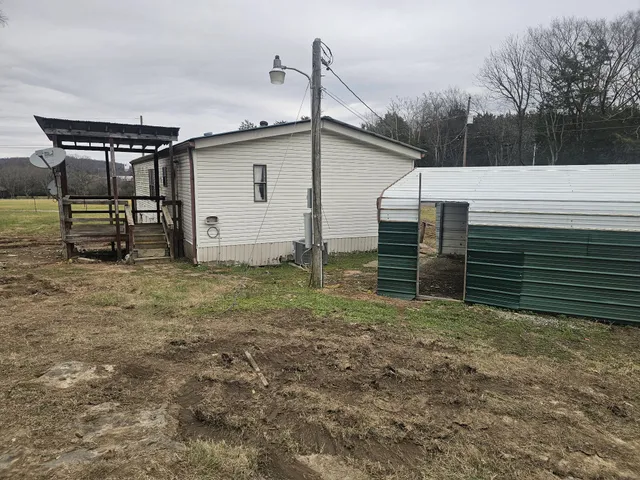 a view of a backyard with large trees