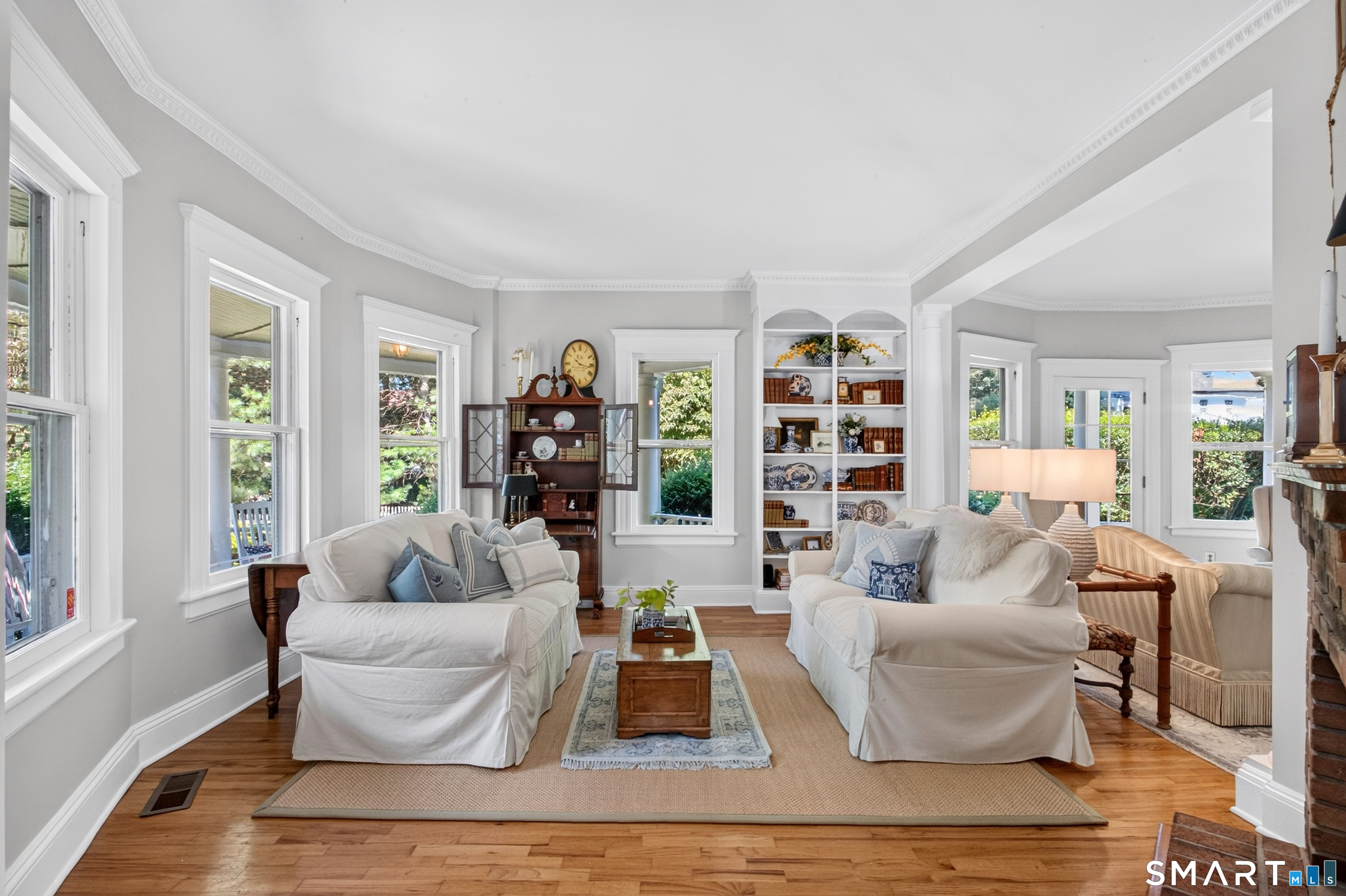 239 Beach Road Fairfield, CT 06824 - Photo 6 of 40 Living room with hardwood floors, 9ft + ceilings, custom bulit in.
