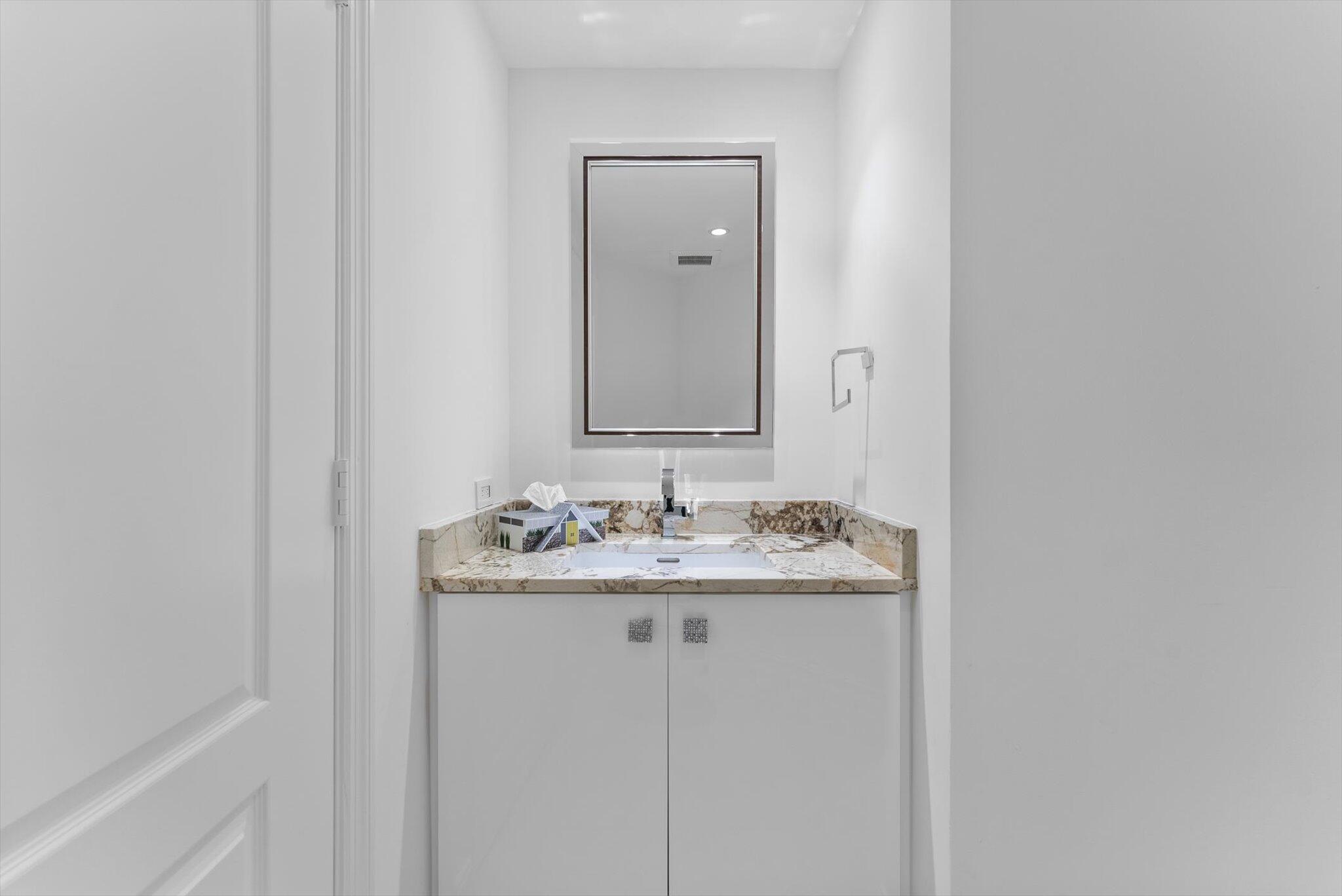 550 Southeast Mizner Boulevard, Unit B206 Boca Raton, FL 33432 - Photo 11 of 65 a bathroom with a granite countertop sink and a mirror