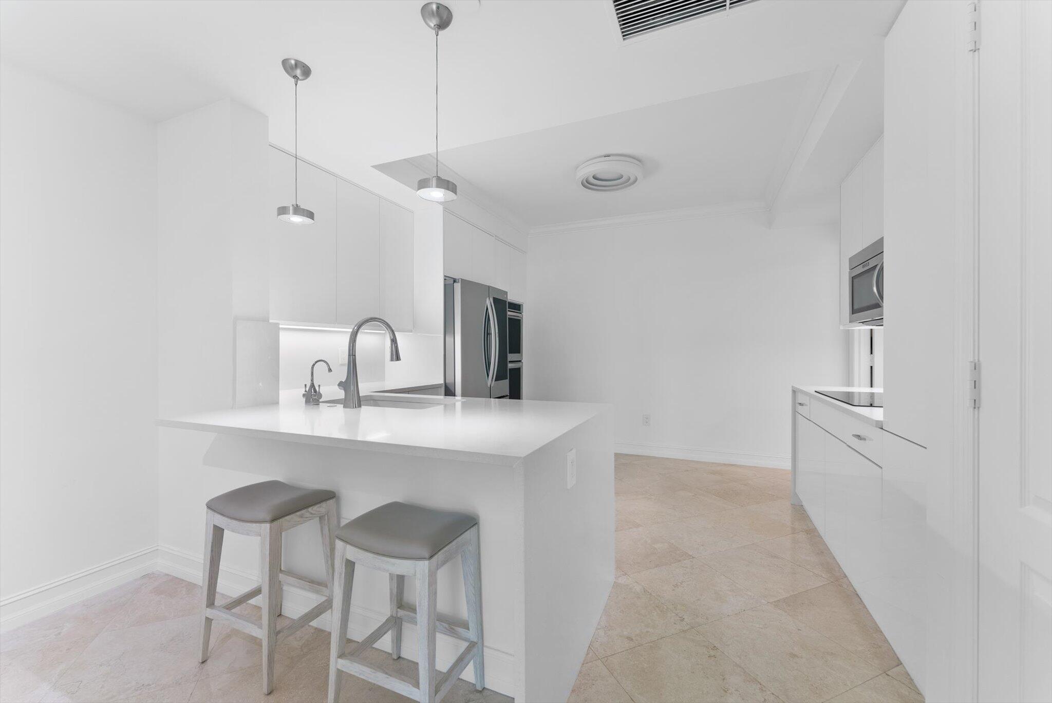 550 Southeast Mizner Boulevard, Unit B206 Boca Raton, FL 33432 - Photo 24 of 65 a kitchen with cabinets a sink and appliances