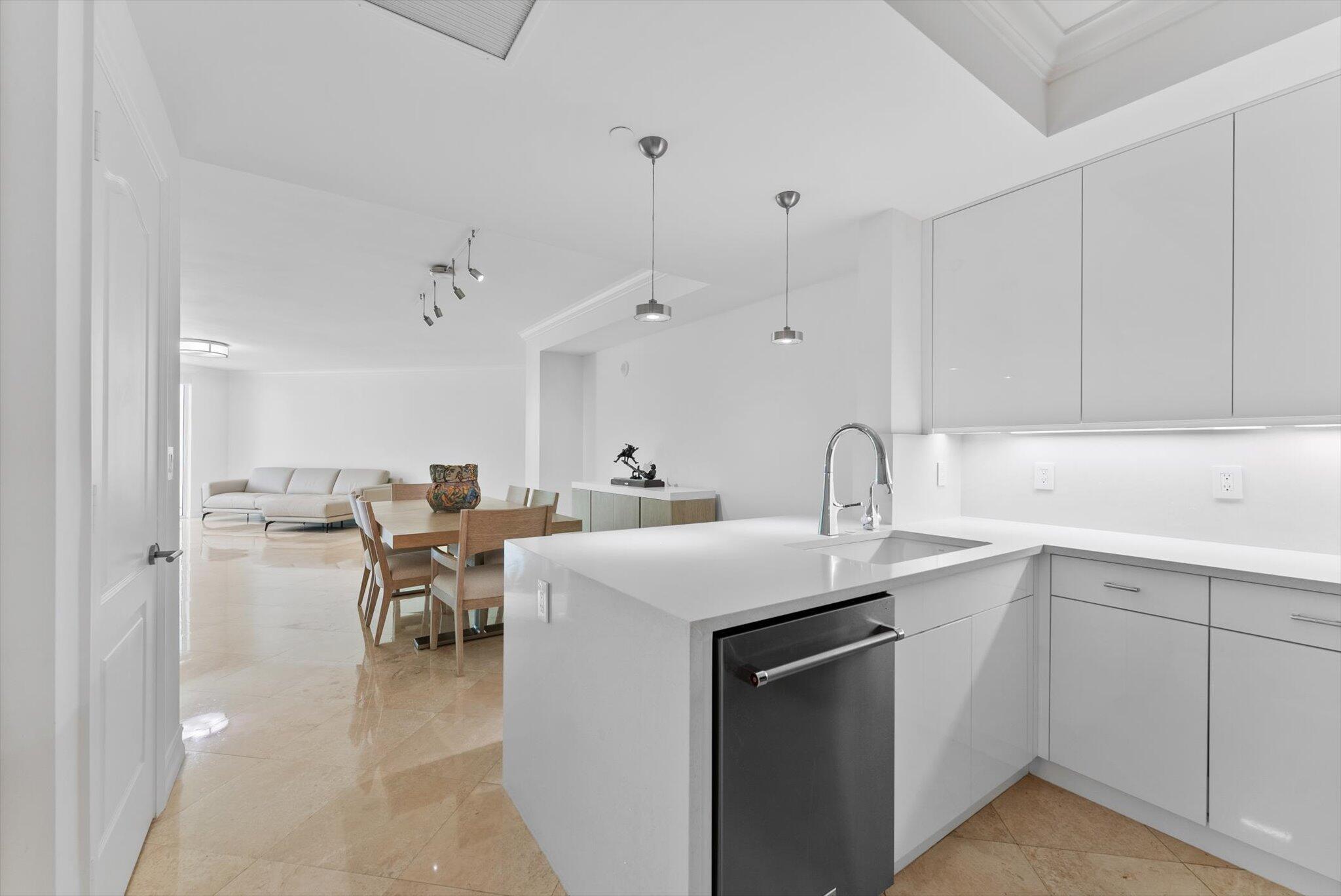 550 Southeast Mizner Boulevard, Unit B206 Boca Raton, FL 33432 - Photo 25 of 65 a view of a kitchen with a sink a kitchen island a stove a couch and a window