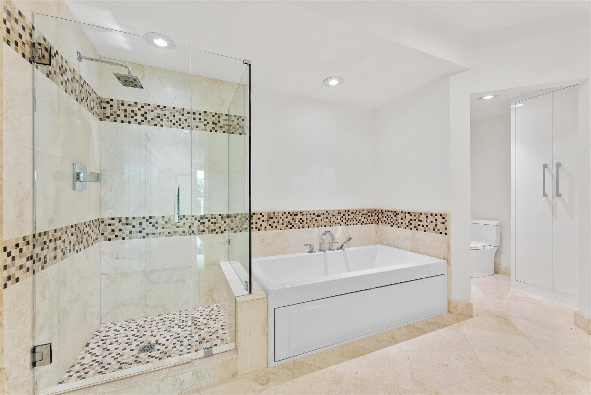 550 Southeast Mizner Boulevard, Unit B206 Boca Raton, FL 33432 - Photo 32 of 65 a bathroom with a tub a rug and a shower