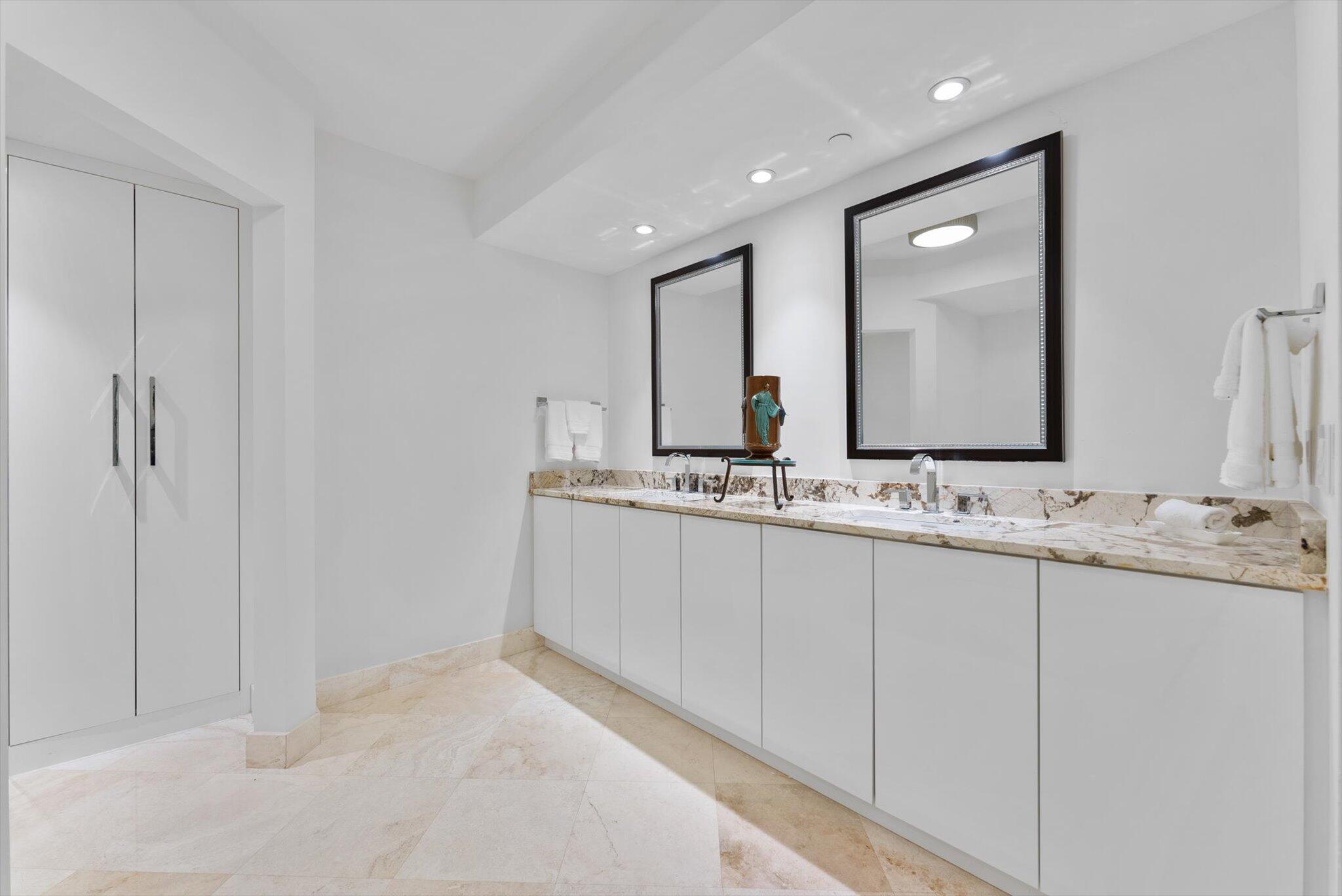 550 Southeast Mizner Boulevard, Unit B206 Boca Raton, FL 33432 - Photo 33 of 65 a bathroom with a double vanity sink and mirror