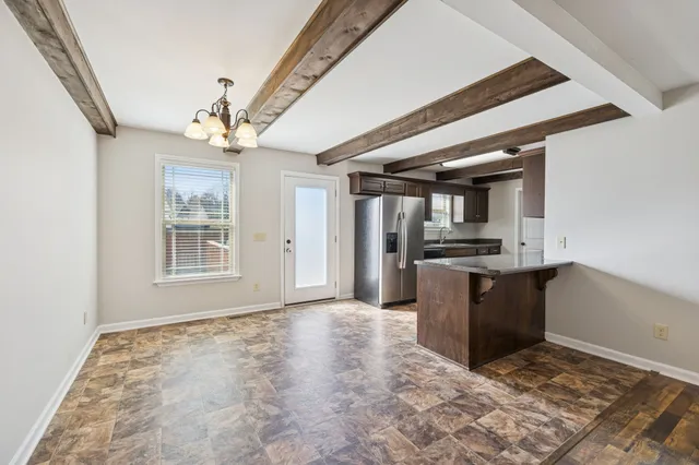 a view of kitchen with sink microwave and refrigerator