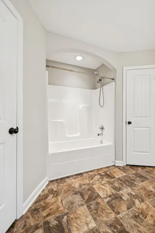 a bathroom with a bathtub and a shower