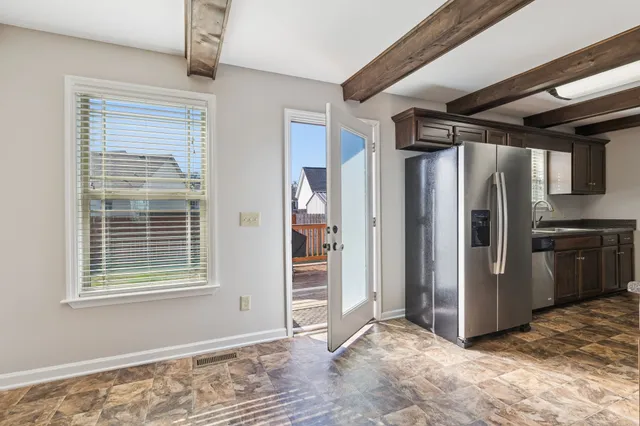 a view of a house with backyard and porch