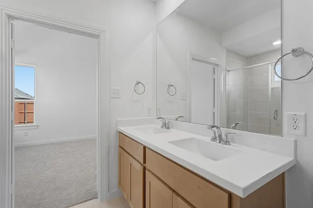 a bathroom with a sink toilet a mirror and shower