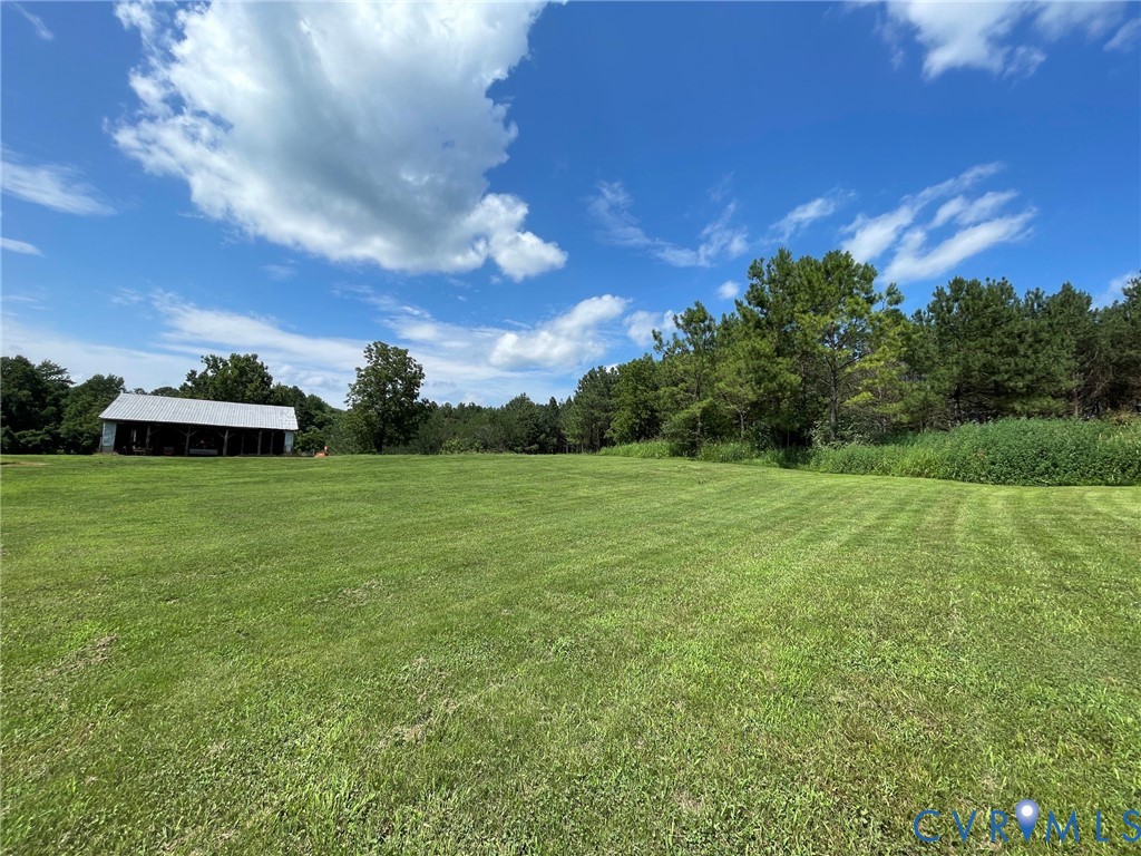 1 Deer Run Road Blackstone, VA 23824 - Photo 11 of 17 Expansive green lawn with a distant open-sided str