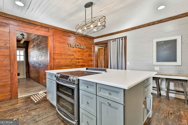 a view of a kitchen wooden cabinets and a stove
