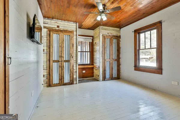 a bathroom with a granite countertop sink toilet a mirror and shower