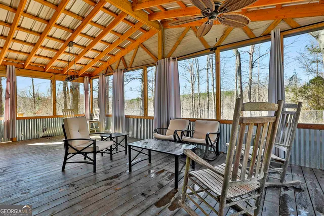 a view of an empty room with wooden floor fireplace and a window
