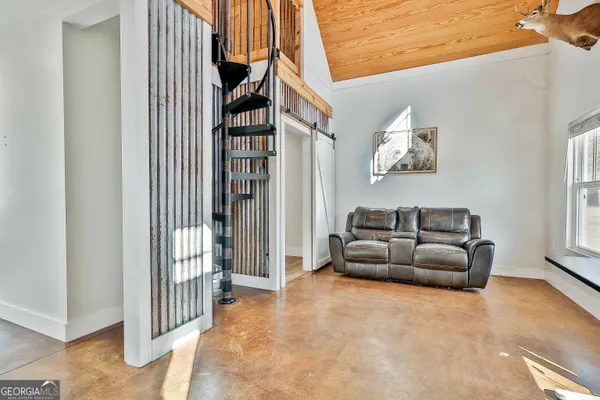 a view of living room kitchen with furniture and flat screen tv
