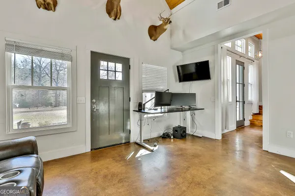 a living room with furniture and a flat screen tv