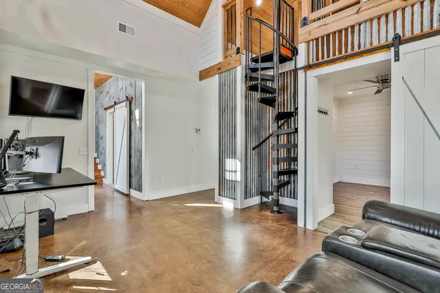 a view of a livingroom with workspace and a couch