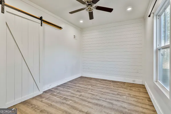 a view of walk in closet with empty room