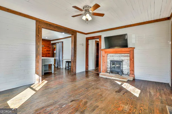 a view of an empty room with a fireplace and a window