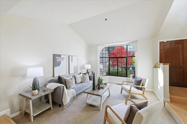 a living room with furniture window and a refrigerator