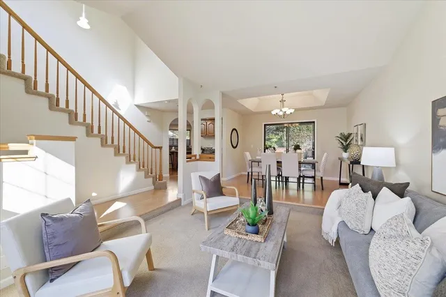 a living room with furniture or wooden floor and a chandelier