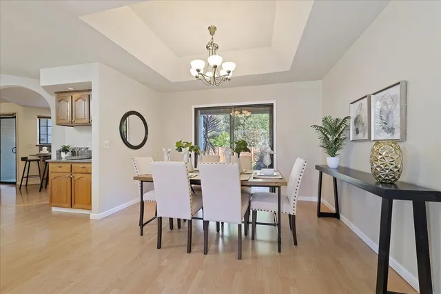 a view of a dining room with furniture and chandelier