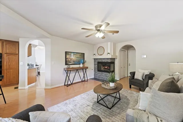 a living room with furniture a fireplace and a table