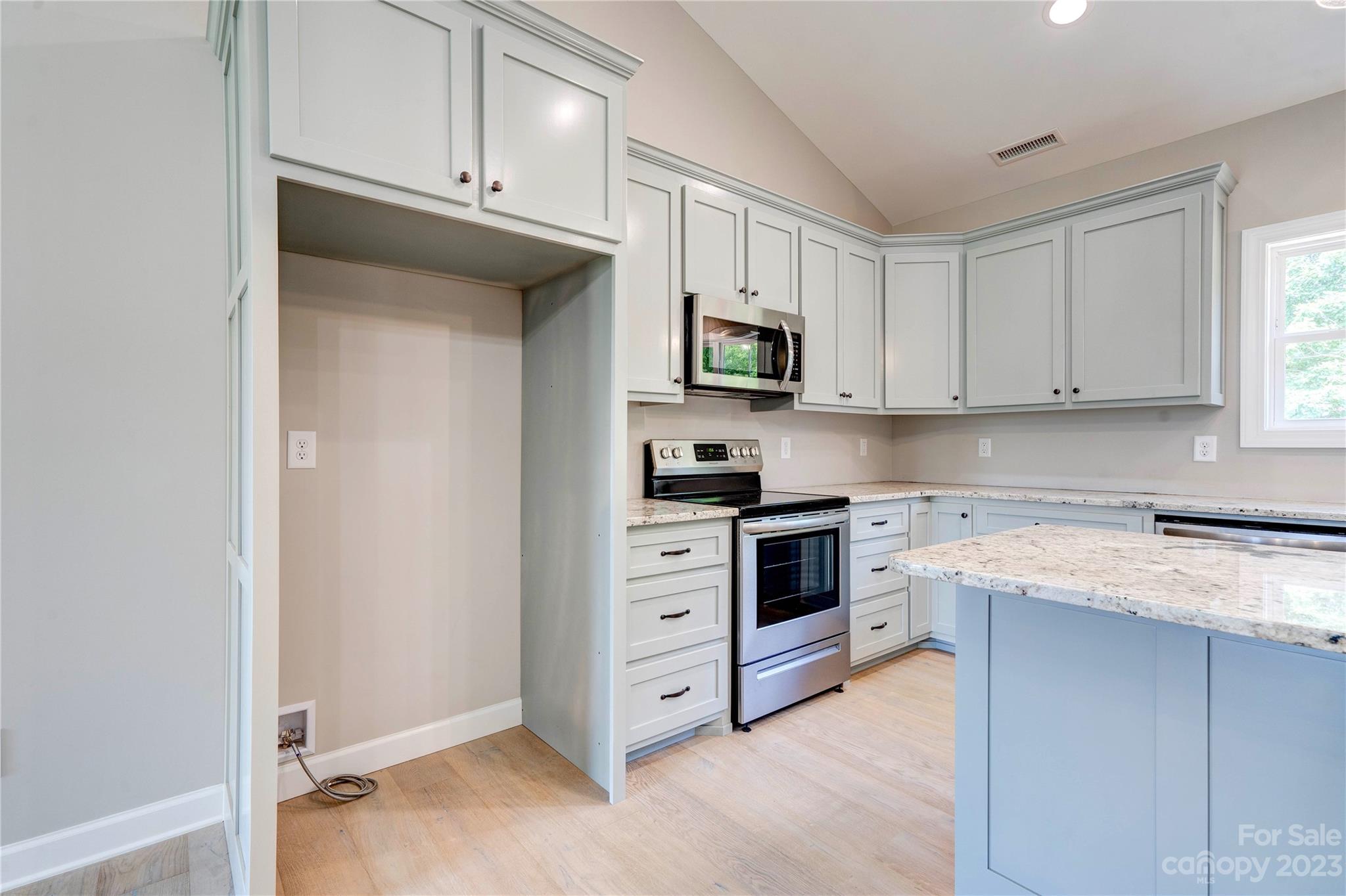 4326 Boulder Drive Morganton, NC 28655 - Photo 11 of 46 a kitchen with white cabinets and appliances