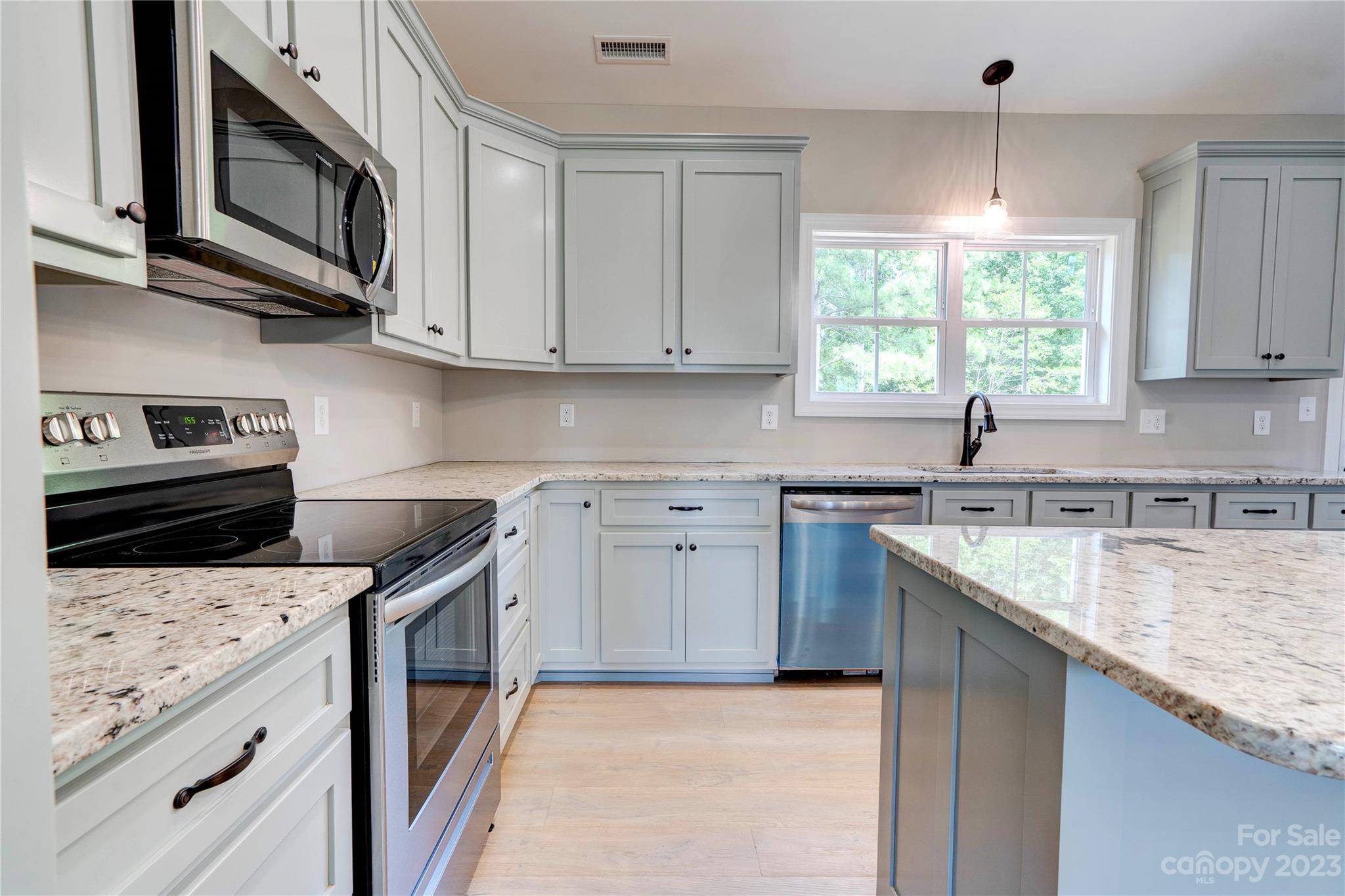 4326 Boulder Drive Morganton, NC 28655 - Photo 14 of 46 a kitchen with granite countertop a sink a stove and cabinets