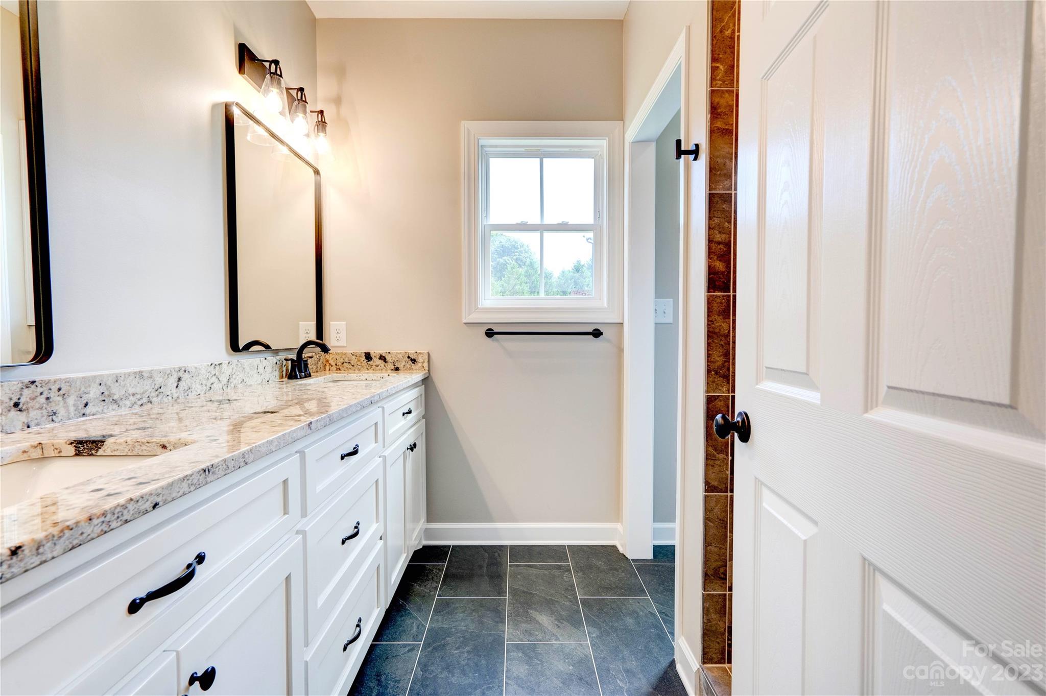 4326 Boulder Drive Morganton, NC 28655 - Photo 20 of 46 a bathroom with a granite countertop sink and a mirror