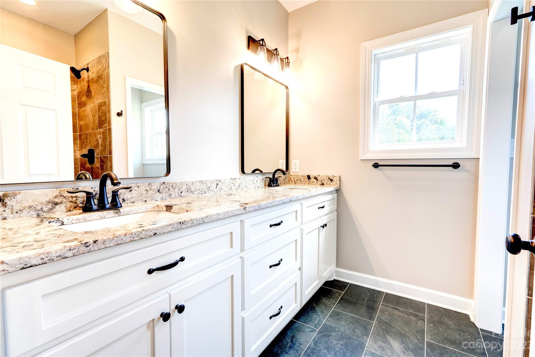 4326 Boulder Drive Morganton, NC 28655 - Photo 21 of 46 a bathroom with double sink and a mirror