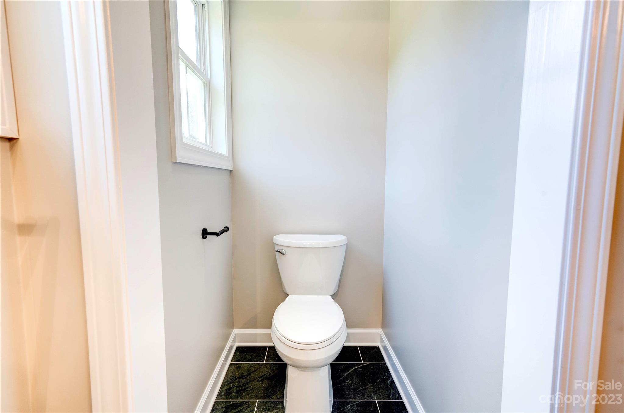 4326 Boulder Drive Morganton, NC 28655 - Photo 23 of 46 a white toilet sitting in a bathroom next to a window