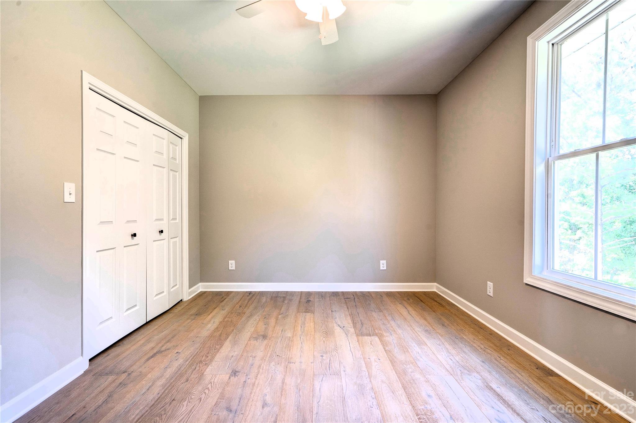 4326 Boulder Drive Morganton, NC 28655 - Photo 29 of 46 an empty room with wooden floor and windows