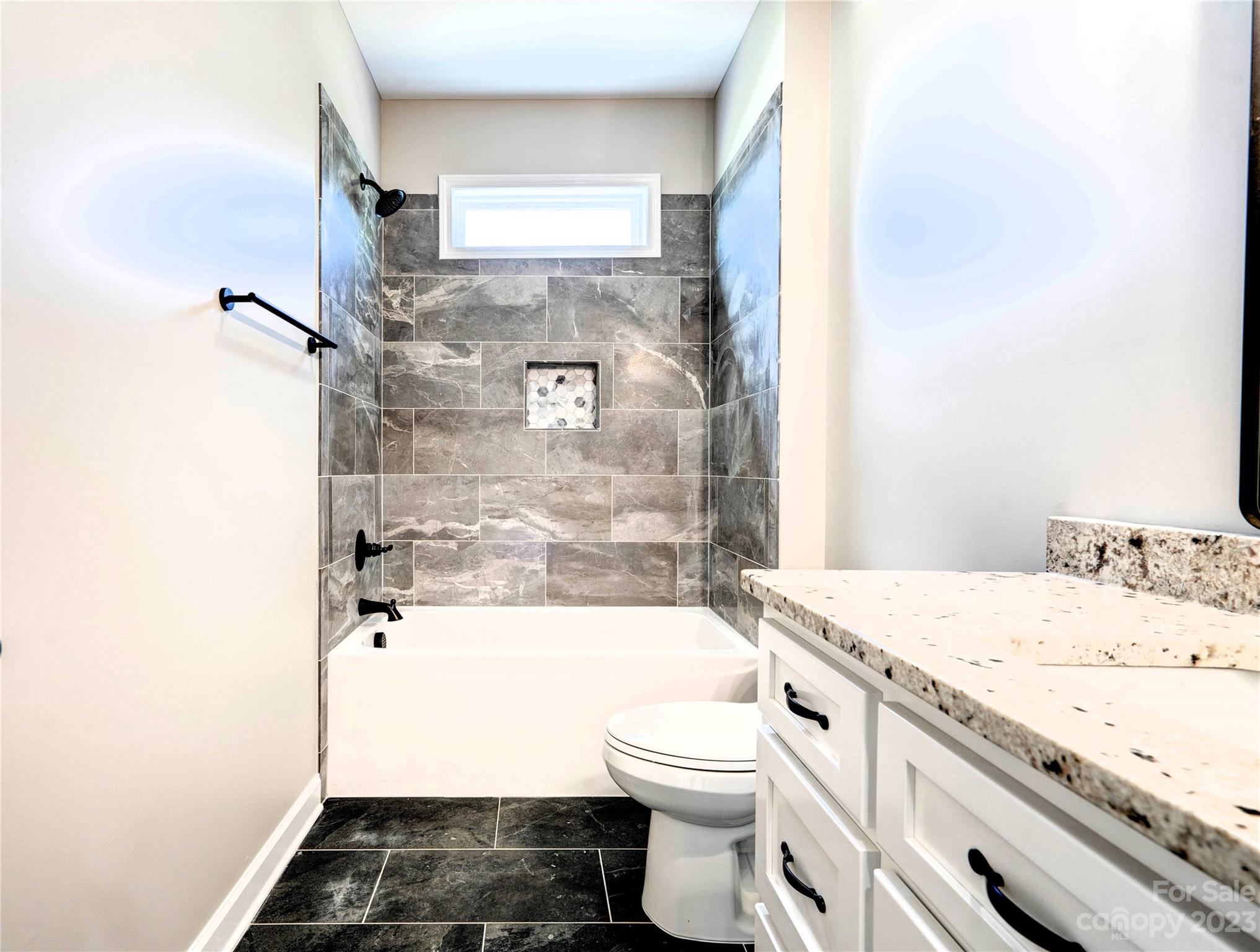 4326 Boulder Drive Morganton, NC 28655 - Photo 31 of 46 a bathroom with a granite countertop toilet a sink and bathtub