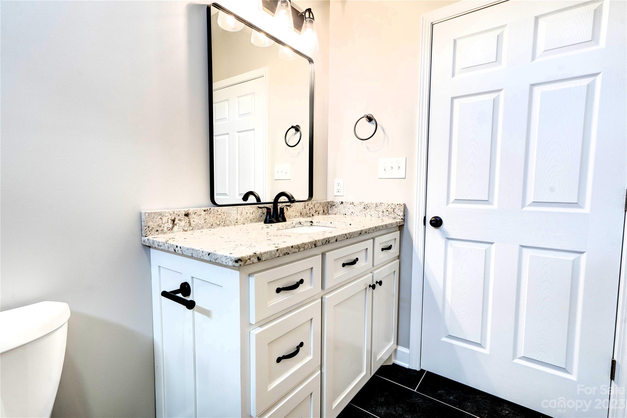 4326 Boulder Drive Morganton, NC 28655 - Photo 32 of 46 a bathroom with a granite countertop sink and a mirror