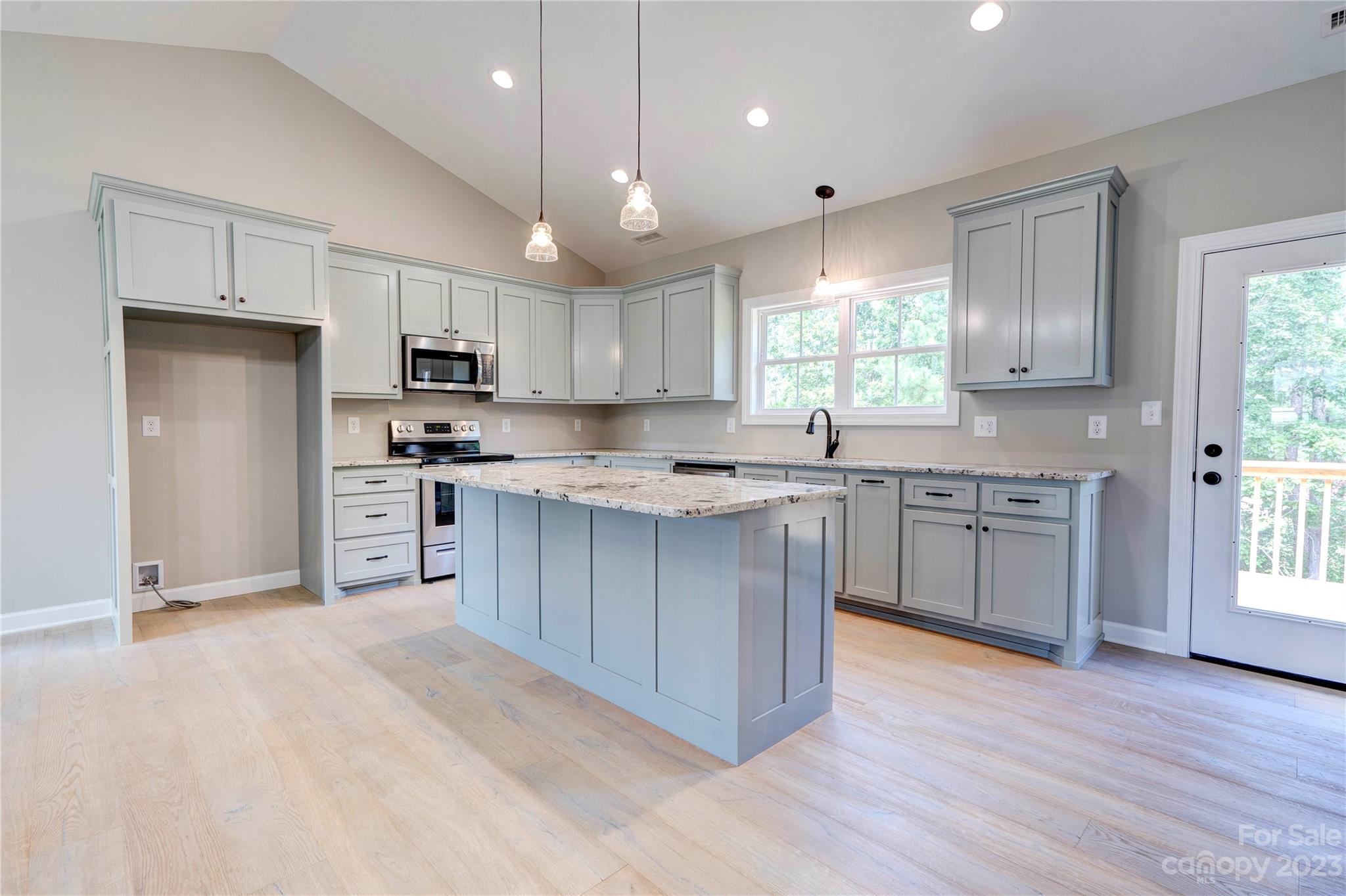 4326 Boulder Drive Morganton, NC 28655 - Photo 9 of 46 a kitchen with stainless steel appliances granite countertop a stove a sink dishwasher a refrigerator and white cabinets with wooden floor