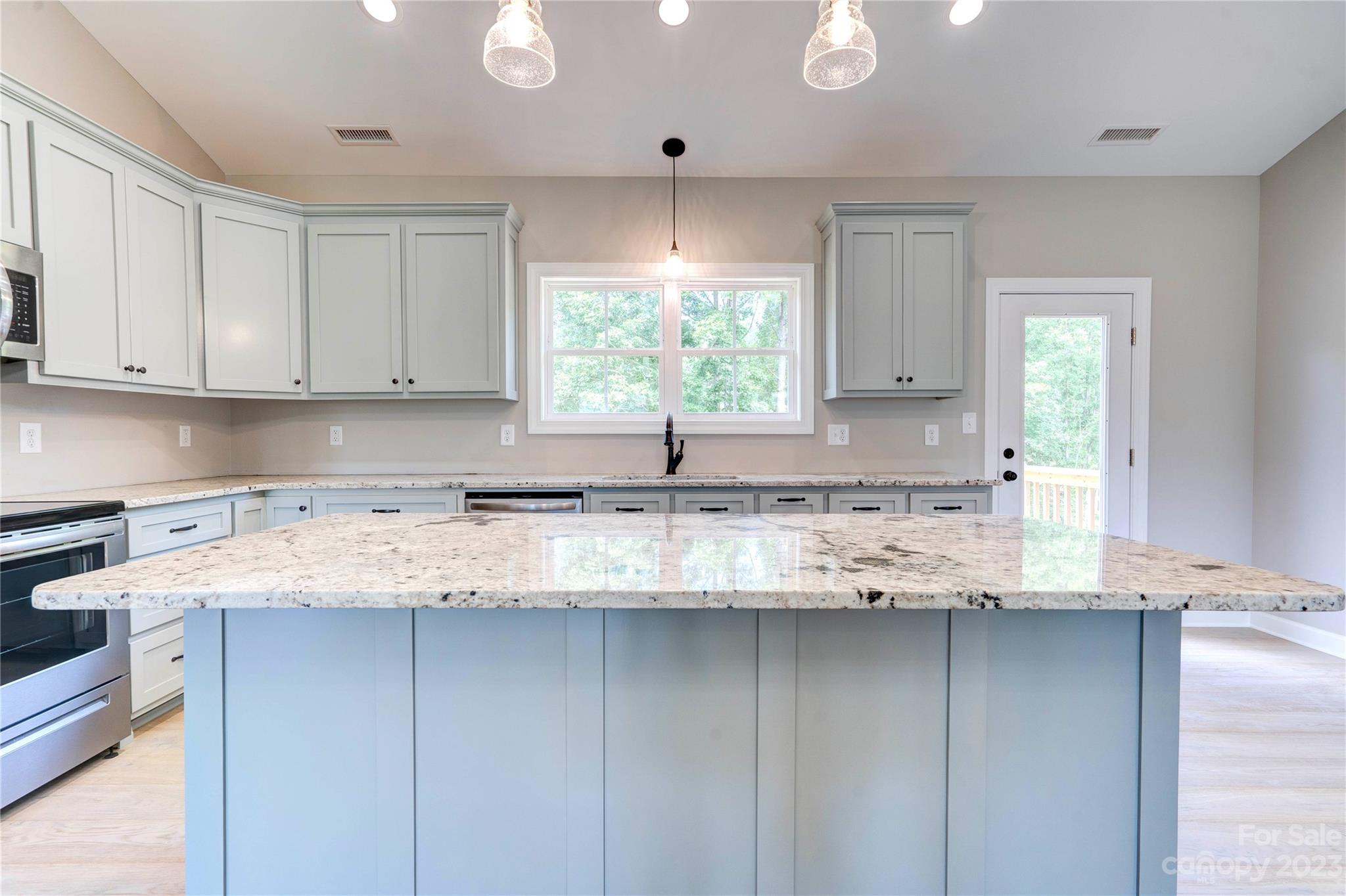 4326 Boulder Drive Morganton, NC 28655 - Photo 10 of 46 a kitchen with granite countertop a sink window and cabinets