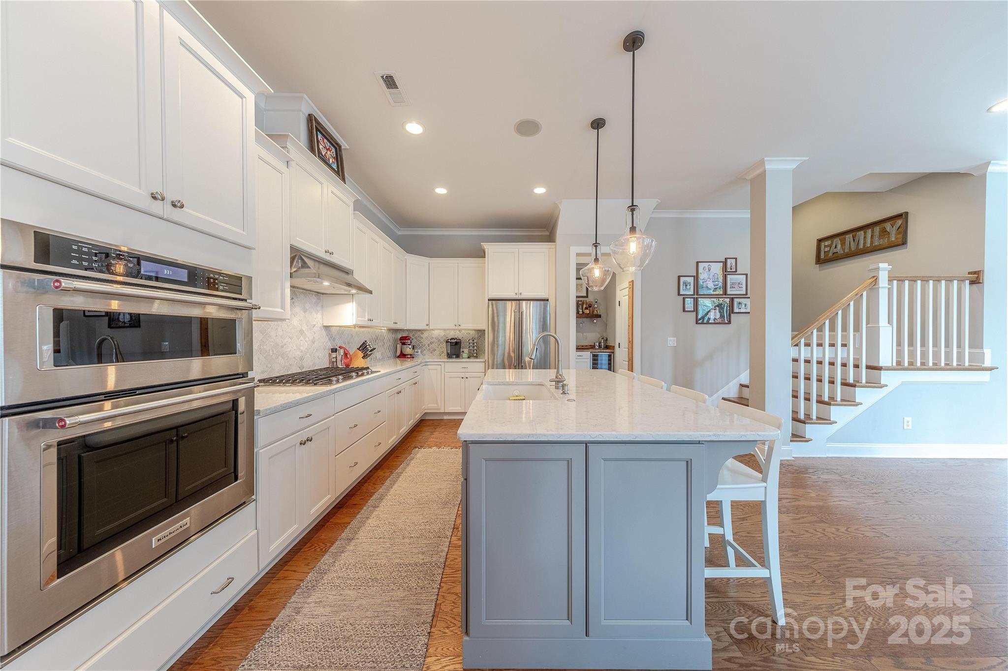 5256 Meadowcroft Way Fort Mill, SC 29708 - Photo 11 of 48 a kitchen with stainless steel appliances kitchen island granite countertop a sink and white cabinets