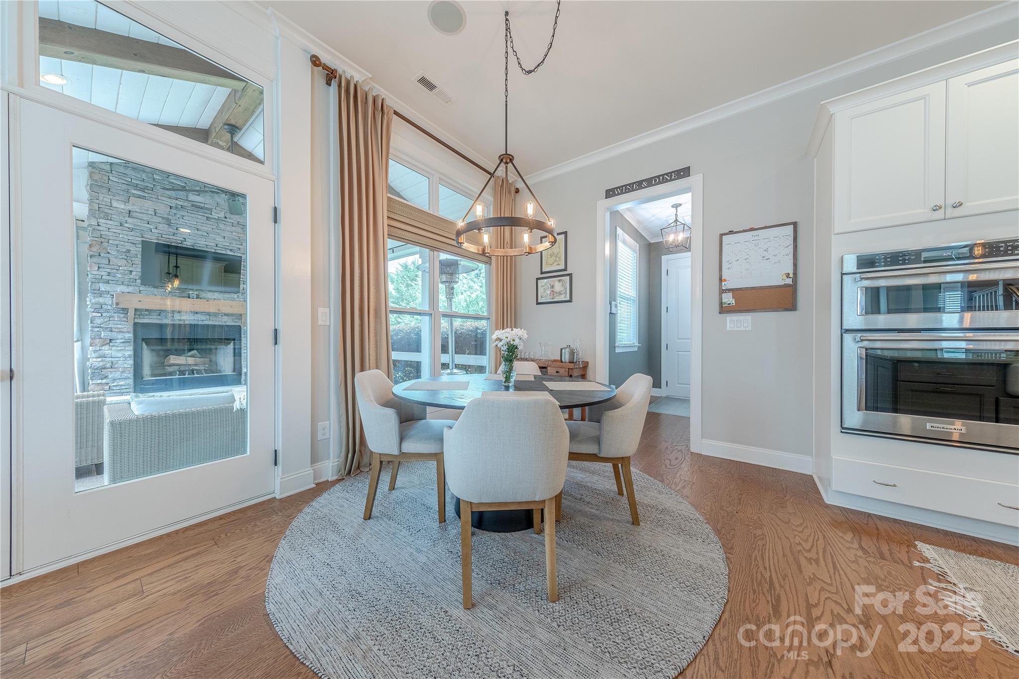5256 Meadowcroft Way Fort Mill, SC 29708 - Photo 14 of 48 a dining room with furniture a chandelier and wooden floor