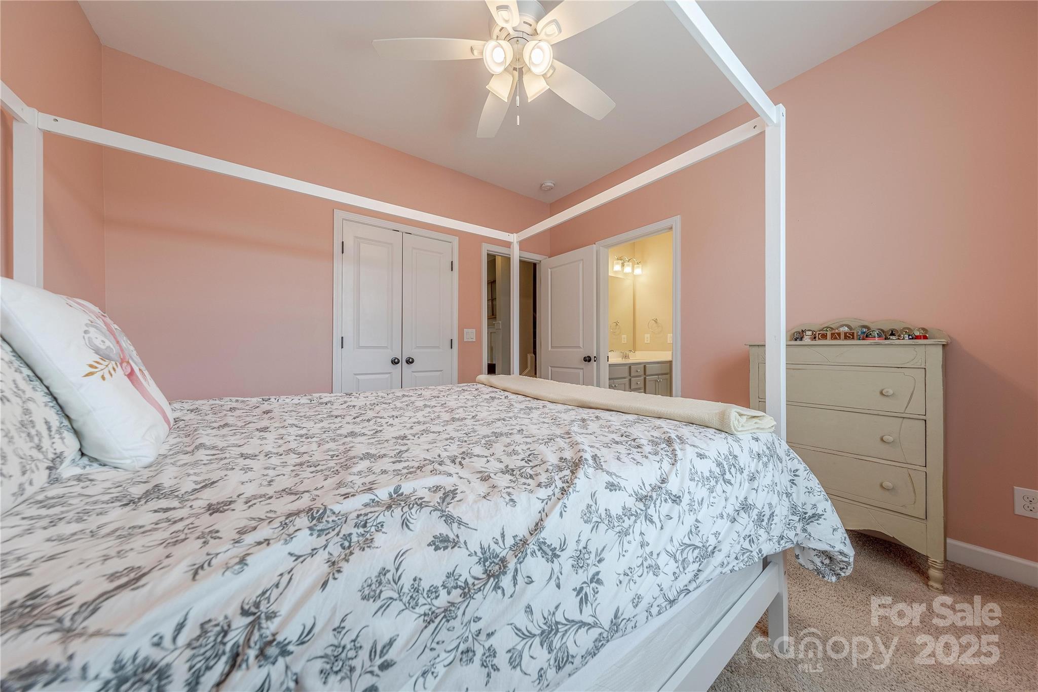 5256 Meadowcroft Way Fort Mill, SC 29708 - Photo 36 of 48 a bedroom with a bed and a chandelier