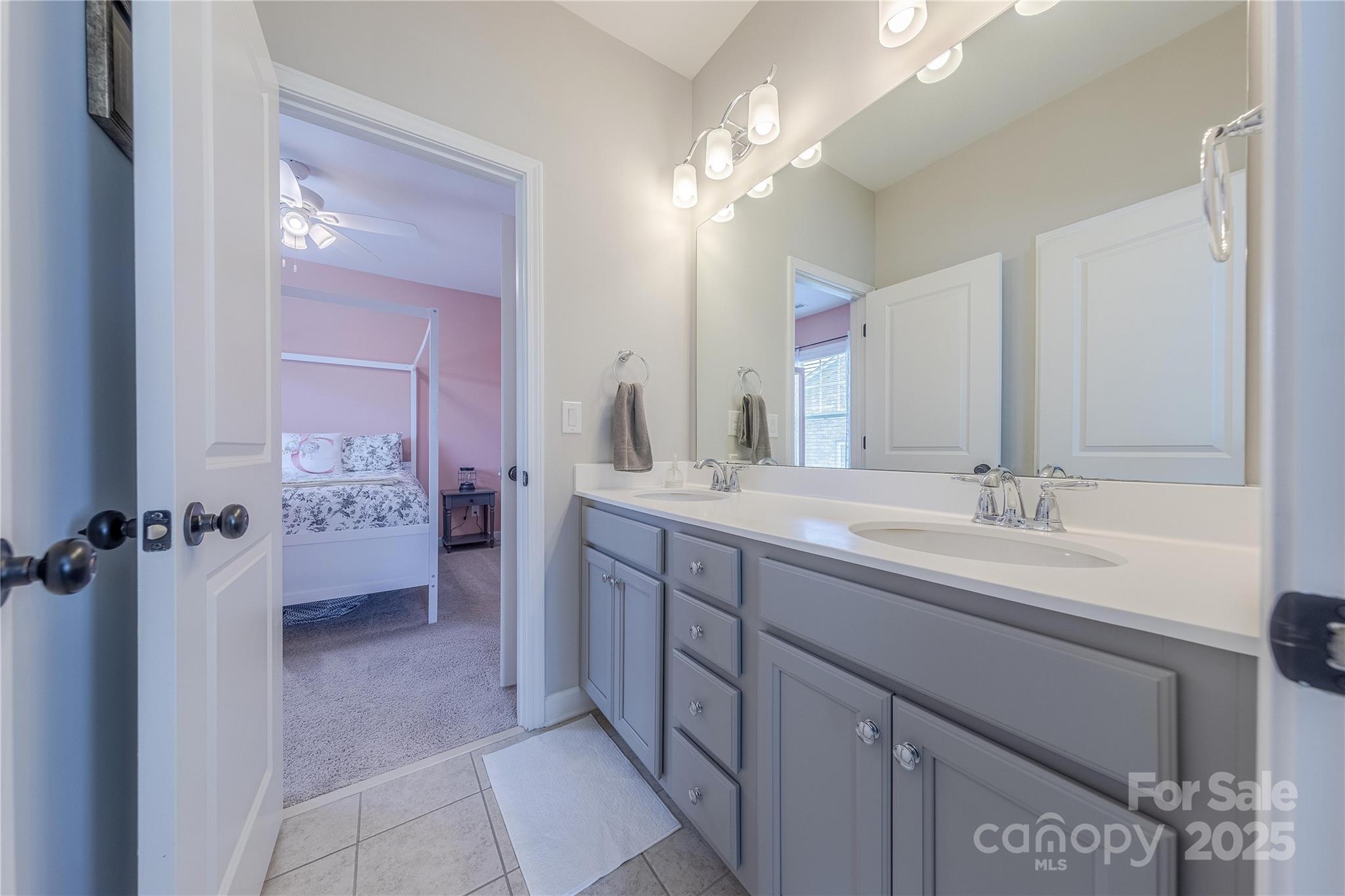 5256 Meadowcroft Way Fort Mill, SC 29708 - Photo 37 of 48 a bathroom with a double vanity sink a mirror and a shower